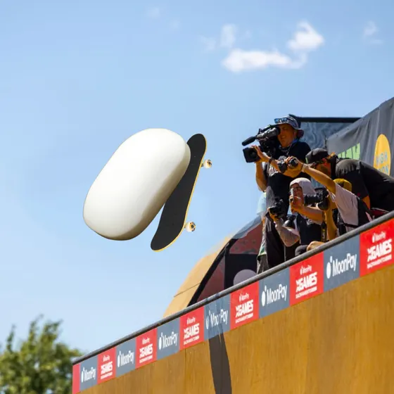 Bar of soap on skateboard doing a trick with spectators watching.