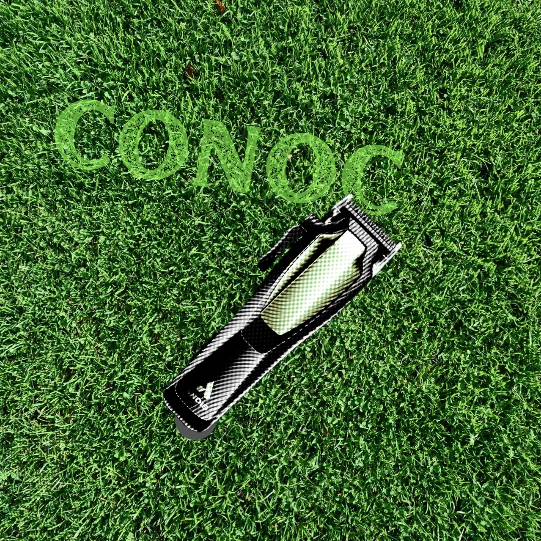 Top-down view of the word 'CONOC' cut into a field of grass with a shaving razor.